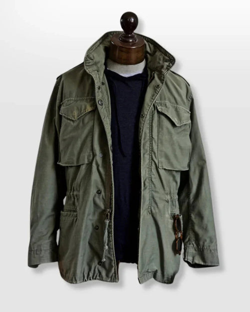 Men's durable utility field jacket designed for outdoor activities, featuring multiple pockets for storage and a rugged, weather-resistant fabric suitable for various environments. 0