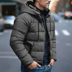 Men's insulated quilted puffer jacket featuring an adjustable hood, designed for warmth and comfort in cold weather. 0