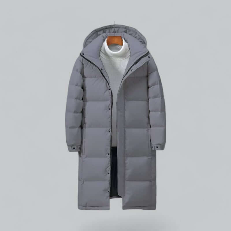 Men's longline quilted winter coat featuring a hood and snap-button cuffs, ideal for warmth and style in cold weather. 2